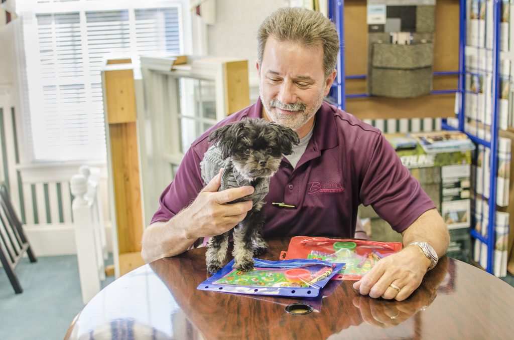 Owner, Chris Balducci, getting some help from our office pup, Zoey
